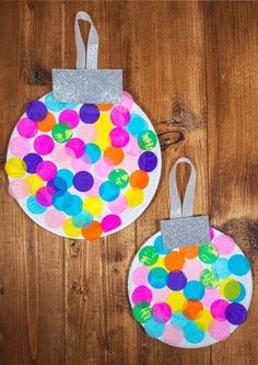 two paper plates with different colored dots on them, one is hanging from the wall