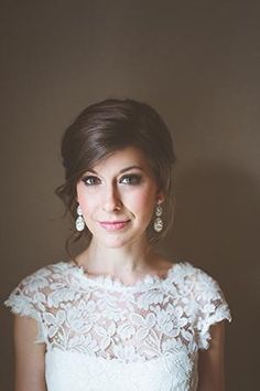 a woman in a white dress is posing for a photo with her hands on her hips