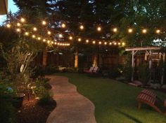 an outdoor patio with lights strung over it