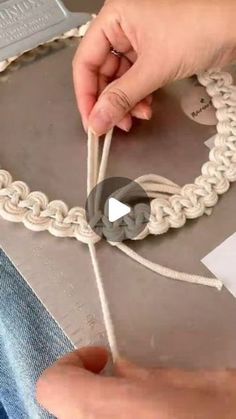 someone is making something out of rope with scissors