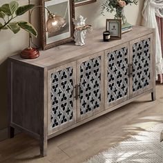 a wooden sideboard with two framed pictures on it