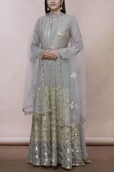 Grey floor-length anarkali with all over mirror embroidery. Comes with matching dupatta.
Components:2
Mirror embroidered
Neckline:Mandarin collar
Sleeve Length:Full
Fabric:Georgette
Color:Grey
Split neckline
Embroidered dupatta with lace - Aza Fashions Lehenga Bollywood, Anarkali With Dupatta, Silk Anarkali Suits, Floor Length Anarkali, Embroidered Anarkali, Lehenga Wedding, Lehenga Collection, Embroidered Neckline, Suit Designs