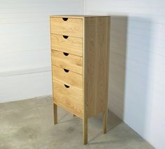 a wooden cabinet with four drawers in a room