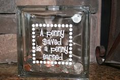 a glass block that has some coins in it and the words a penny saved is a penny earner