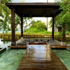 an outdoor living area with couches and tables