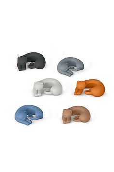 six different colored animal shaped objects on a white surface