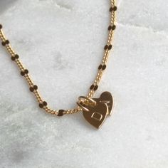 Our tiny heart initial necklace is dainty and meaningful, tiny initial hearts on a 14kt gold gilled chain. This classic necklace is great for everyday wear or layering. Choose your number of hearts and wear your favorite initials close to your heart.•Dainty heart measures 8mm•Choose up to 4 hearts.•14kt Gold-Filled curb dapped chain. •Stamped by hand with an initial of your choice. •The heart can also be left blank or hammered. •Satin finish Dainty Personalized Heart Necklace With Initial, Elegant Gold Heart-shaped Initial Necklace, Dainty Heart-shaped Name Necklace For Personalized Gift, Dainty Heart-shaped Personalized Name Necklace, Personalized Heart-shaped Initial Necklace For Everyday, Heart Initial Necklace, 3 Hearts, Classic Necklace, Gem Necklace