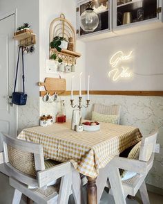 a dining room table with two chairs and a light that reads good luck on it