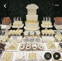 a table topped with lots of donuts and desserts