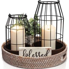 two candles are sitting in a basket with a sign