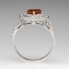 a fancy ring with an oval cut diamond in the center