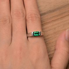 It is a lab emerald ring. The main stone is 5mm*7mm emerald cut, weight about 0.87 carats. The basic metal is sterling silver and plated with rhodium. To change the metal to a solid gold (white/rose) or platinum is also available, please ask for a quotation if you want. You can also go to my shop Home for more elegant rings: https://www.etsy.com/shop/godjewelry?ref=hdr_shop_menu More emerald rings: https://www.etsy.com/shop/godjewelry?section_id=20709240 Customization is always welcome and pleas Minimalist Emerald Cut May Birthstone Ring, Minimalist May Birthstone Ring With Emerald Cut, Modern Emerald Cut Emerald Ring With Tension Setting, Emerald Cut Emerald Jewelry With Tension Setting, Emerald Jewelry With Tension Setting In Emerald Cut, Minimalist Emerald Cut Emerald Ring, Modern Emerald Cut Emerald Ring For Anniversary, Emerald Cut Ring With Tension Setting In Emerald, Modern Emerald Cut Ring For Anniversary