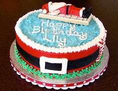 a birthday cake decorated with santa claus and his sleigh on the top layer