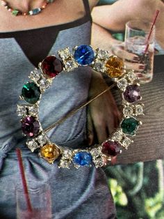 "Stunning Colorful Large Rhinestones in Circular Pin. This pin has such clarity and brightness in all the stones. The colors include; garnet, emerald, citrine, blue sapphire, amethyst.  There are two stones of each color and they each have four prongs. There are two clear smaller rhinestones between each colored stone and each have four prongs. The pin is 1 5/8\" in diameter.  It has a spring ring clasp with pin.  The setting is a silver tone shiny metal.  Free Shipping in the U.S. when Purchasi Colored Stone, Crystal Brooch, Rhinestone Brooches, Lovely Earrings, Color Crystal, Vintage Gifts, Spring Rings, Citrine, Blue Sapphire