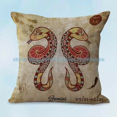 a decorative pillow with two snakes on it