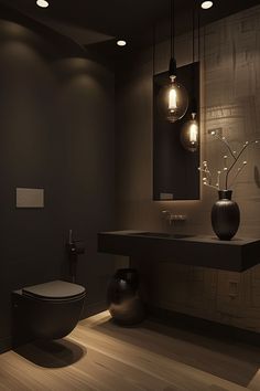 a bathroom with a toilet, sink and lights on the wall above it's counter