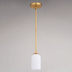 a white and gold light hanging from a ceiling