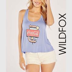 Wildfox The “Think Of Coke” Blue Tank Top Is Made With The Softest Modal Fabric With A Scoop Neck And Curved Bottom Hemline. Measurements (Flat): Bust 19” Length 23.5” I’d Be Happy To Answer Any Questions You May Have, So If You Would, Please Ask Prior To Purchasing. Thank You! Cute Blue Tank Top For Summer, Cute Blue Summer Tank Top, Blue Scoop Neck Top For Vacation, Blue Graphic Print Top For Day Out, Retro Blue Tops For Day Out, Blue Scoop Neck Summer Tops, Chic Blue Top With Graphic Print, Purple Tank Top, Modal Fabric