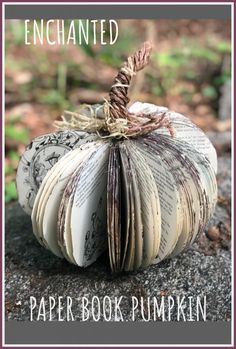 an open book pumpkin sitting on top of a rock with the title, enchanted paper book pumpkin