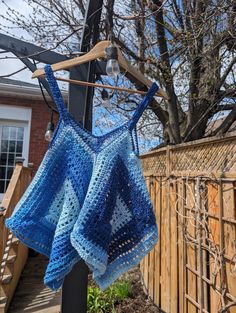 Handmade Crochet Kanata Kerchief Tank - Perfect for Springtime Chic Description: Step into spring with style in our handmade crochet Kanata Kerchief Tank! This charming and versatile top is the perfect addition to your warm-weather wardrobe, offering a blend of bohemian flair and contemporary chic. Crafted with care and attention to detail, each tank features a flattering kerchief hemline and intricate crochet detailing that adds texture and visual interest. The lightweight and breathable design Beach Crochet Top With Crochet Trim, Hand Knitted Cotton Tops For Beach, Handmade Blue Cotton Crochet Top, Summer Handmade Crochet Top, Handmade Yarn Crochet Top For Summer, Summer Beach Yarn Tops, Crochet Tops With Yarn For Beach, Crochet Yarn Tops For Beach, Summer Crochet Yarn Tops