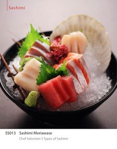 a black plate topped with different types of sushi