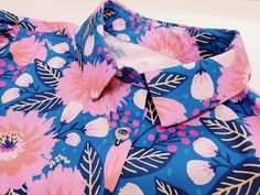 a shirt with pink and blue flowers on it