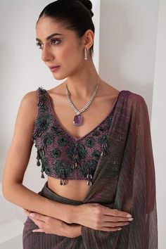 Purple metallic toned pre-draped saree crafted in platinoir crepe. Paired with a sleeveless V neck blouse with tonal crystal tassel and cutdana embellishments. - Aza Fashions Reception Pre-draped Saree With Unstitched Blouse, Sleeveless Pre-draped Saree For Diwali, Sleeveless Blouse With Zari Work For Evening, Fusion Style Blouse Piece For Diwali, Fusion Blouse Piece For Diwali, Bollywood Style Sleeveless Evening Blouse, Evening Sleeveless Bollywood Blouse Piece, Evening Bollywood Sleeveless Blouse, Sleeveless Choli For Evening And Diwali