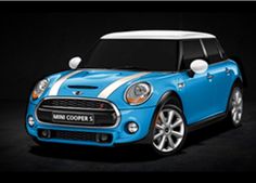 a blue mini cooper with white stripes on the front and side, parked in a dark room