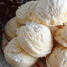 a pile of powdered sugar cookies sitting on top of a table