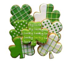 shamrock cookies decorated with green and white icing are arranged in the shape of clovers