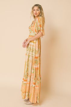 A printed woven maxi dress featuring plunging V neckline, flutter sleeve, waist yoke, tiered skirt, surplice back with tie and smocked back waist band Details Self: 100% Polyester Lining: 100% Polyester Size & Fit - Model is 5`8" And Wearing Size Small - Measurements Taken From Size Small - Approx. Length: 49" Bohemian Dress With Butterfly Sleeves For Brunch, Bohemian Flutter Sleeve Printed Dresses, Printed Maxi Length V-neck Dress, Flowy Printed Dress With Flutter Sleeves, Bohemian Dresses With Flutter Sleeves For Brunch, Bohemian Fitted Dresses With Flutter Sleeves, Printed Flutter Sleeve Dresses, Fitted Bohemian Dress With Flutter Sleeves, Bohemian Fitted Dress With Butterfly Sleeves