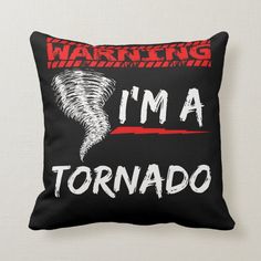 a black pillow that says warning i'm a tornado with red and white stripes