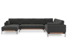 a gray sectional couch with wooden legs and arm rests on an isolated white surface, facing the camera