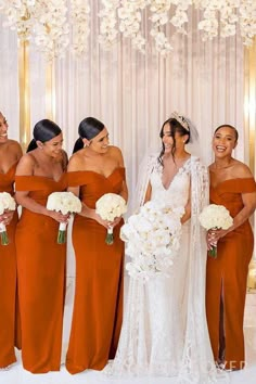 the bride and her bridesmaids are all dressed in orange