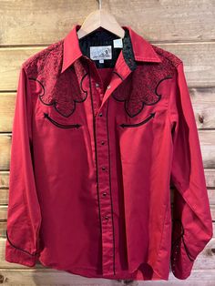 Vintage 70s 80s Roper red and black embroidered western cowboy shirt. Black pearl snaps. Thick, high quality, great condition. Beautiful embroidery! No major flaws. Smoke-free home. See pictures for measurements. Western Style Red Long Sleeve Tops, Red Western Long Sleeve Tops, Red Long Sleeve Western Top, Red Western Style Tops For Ranch, Western Embroidered Shirt For Rodeo, Vintage Red Tops For Rodeo, Cowboy Shirt, Black Cowboy, Cowboys Shirt