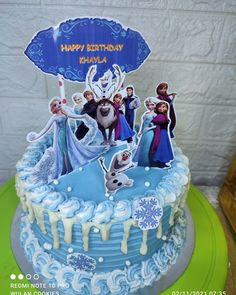 a birthday cake decorated with frozen princess characters