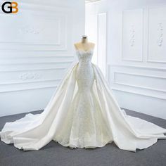 a wedding dress on display in a white room