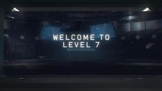 a welcome to level 7 sign is lit up in the middle of a dark room