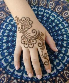 a hand with henna tattoos on it