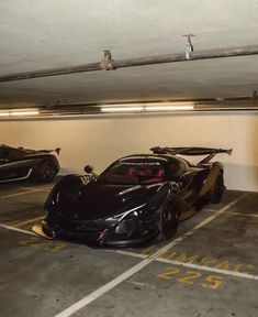 two black sports cars parked in a parking garage