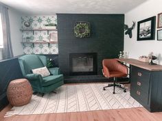 a living room filled with furniture and a fire place next to a desk on top of a hard wood floor