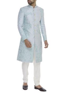 Adorned with beads and thread embroidery on a canvas of blue, this sorbet hued sherwani is all you need to don to put forth a class apart look. Complete this look with gold churidaar to add a touch of royal substance to your collection. 
bead embroidery
thread embroidery
button front closure
mandarin collar
full sleeves
side slits - Aza Fashions Men's Closet, Embroidered Sherwani, Sherwani For Men, Men Closet, Buy Bead, Fashion App, Silk Thread, Indian Design, Raw Silk