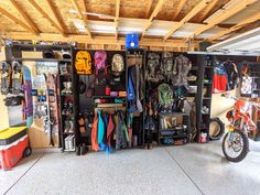 a garage filled with lots of different items and storage space next to a motorbike