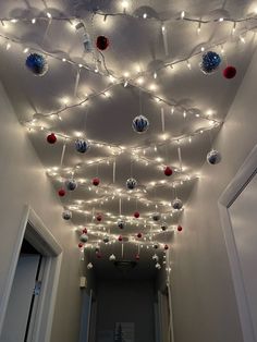 a hallway decorated with christmas lights and ornaments