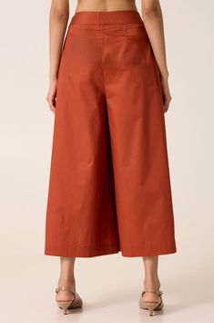 Contemporary high rise trousers. Flared, wide hemline. Ankle grazing length. Clean waistband with a side concealed zip fly. In-seam pockets. Ready Garment Measurements in Inches : XS S M L XL Waist 26 28 30 32 34 Hip 39 41 43 45 47 Length 35.5 35.75 36 36.25 36.5 Workwear Culottes With Elastic Waistband And Cropped Leg, Workwear Culottes With Elastic Waistband, Elastic Waistband Culottes For Workwear, Cropped Leg Culottes With Elastic Waistband For Work, Cotton Culottes For Fall, Fall Cotton Culottes, Cotton Culottes For Workwear, Red Wide Leg Pants With Elastic Waistband For Work, Red Cotton Wide Leg Work Pants