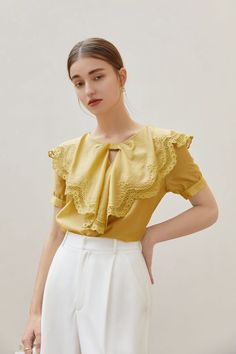 Fabric: 83.7% Lyocell 16.3% Polyester Color: Yellow Care: Hand wash or gentle machine wash A oversized lace bow collar blouse with short puff sleeves. Regular silhouette and slips on. While it has all the usual tropes of a classic blouse , and it is topped with a statement lace collar. Model is 173cm/5'8" tall and wearing a size M. Collar Model, Ruffle Collar Blouse, Classic Blouse, Classic Blouses, Bow Collar, Blouse Short Sleeve, Lace Bows, Ruffle Collar, Fashion Gallery