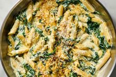 pasta with spinach and parmesan cheese in a pan