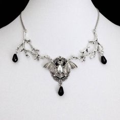 A striking piece of jewelry that embodies the essence of dark magic and Gothic elegance. This intricately designed necklace features a large and detailed bat pendant hanging from a sturdy and stylish chain. The bat pendant is infused with a mysterious energy that radiates from its intricate design, making it a perfect accessory for any wizard or witch seeking to channel their inner power. With its bold and captivating design, this necklace is the perfect statement piece to complete your gothic look. The energy-infused bat pendant adds an air of mystery and intrigue, while the sturdy chain ensures it stays securely around your neck. Whether you're attending a gothic event, seeking to enhance your magical powers, or simply expressing your individuality, the Gothic Mysterious Energy Wizard Ba Gothic Halloween Chain Necklace, Gothic Pendant Necklace For Halloween, Halloween Gothic Pendant Necklace, Gothic Metal Necklace, Black Fantasy Pendant Necklace, Fantasy Black Pendant Necklace, Black Metal Fantasy Necklace, Pagan Magic, Bat Pendant