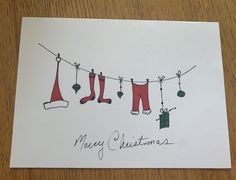 a christmas card with clothes hanging on a line