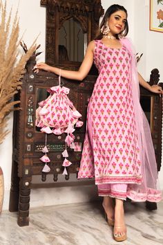 Induce finesse in your traditional wear aesthetics by bringing this hand block print cotton suit set with solid pink pants, and soft net dupatta set in your wardrobe. Crafted in premium quality cotton fabric, this three-piece set will add glamour to your festive events. PRODUCT DESCRIPTION:﻿﻿ Kurta & Pant: Cotton Dupatta: Soft Net ﻿ Color: Pink No. Of Components : Set of 3 Embroidery Details: Hand Block Print with Lace Product Highlight: ﻿Cotton Lining ( Fabric) Wash Care : ﻿Dry Clean Delivery Cotton Suit For Women, Trendy Cotton Suits, Suits For Women Cotton, Cotton Suit Set Design, Pant Suit Designs For Women, Aesthetic Kurta Sets For Women, Cotton Kurta Sets For Women, Cotton Suit Set, Cotton Kurta Set